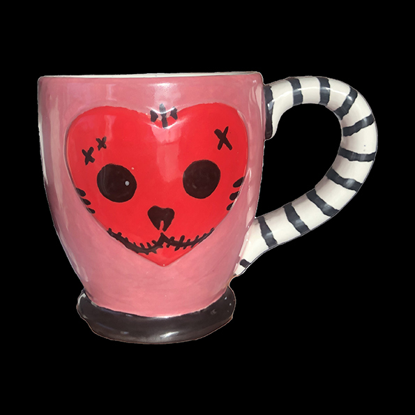 Black, red, and white cup with cat-like face