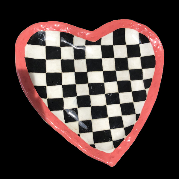 Ceramic heart plate with checkered pattern on inside and pink border around with tiny hearts in it.