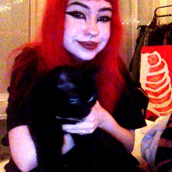 Picture of Svetlana Starodubtseva, girl with red hair and her black cat, Mila.